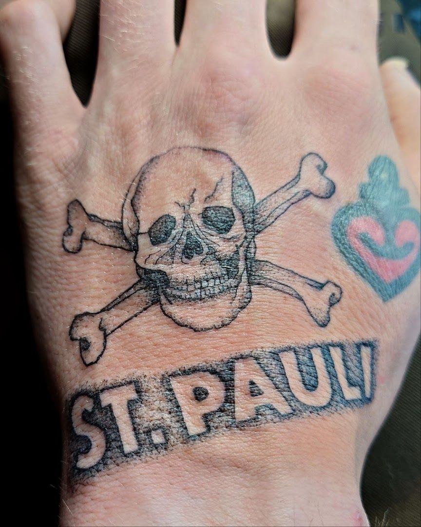 a hand with a skull and crossbone cover-up tattoo on it, neuburg-schrobenhausen, germany