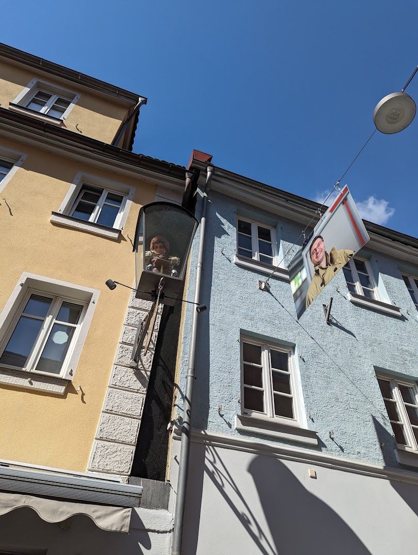 a man is hanging a sign on a building