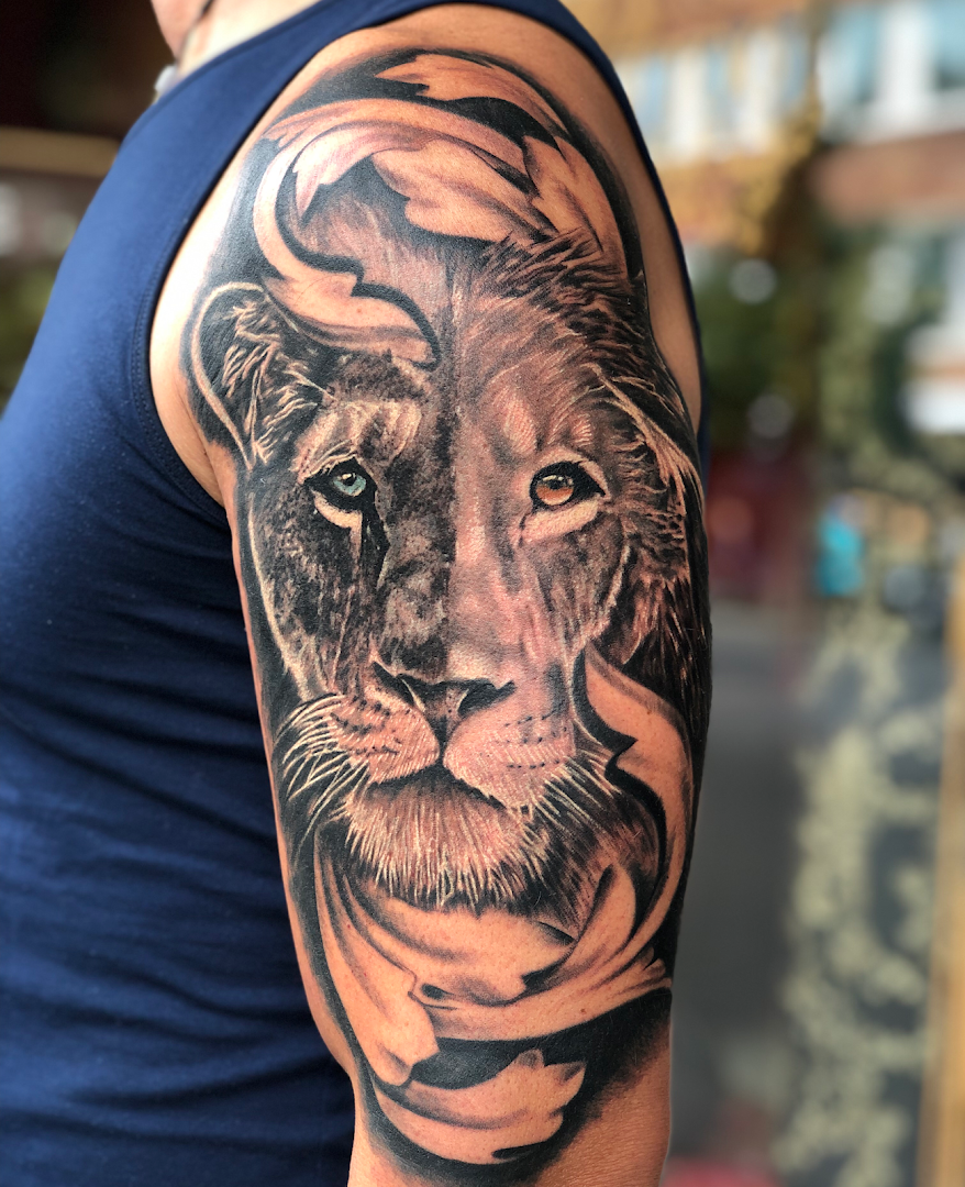 a man with a lion cover-up tattoo on his arm, mönchengladbach, germany