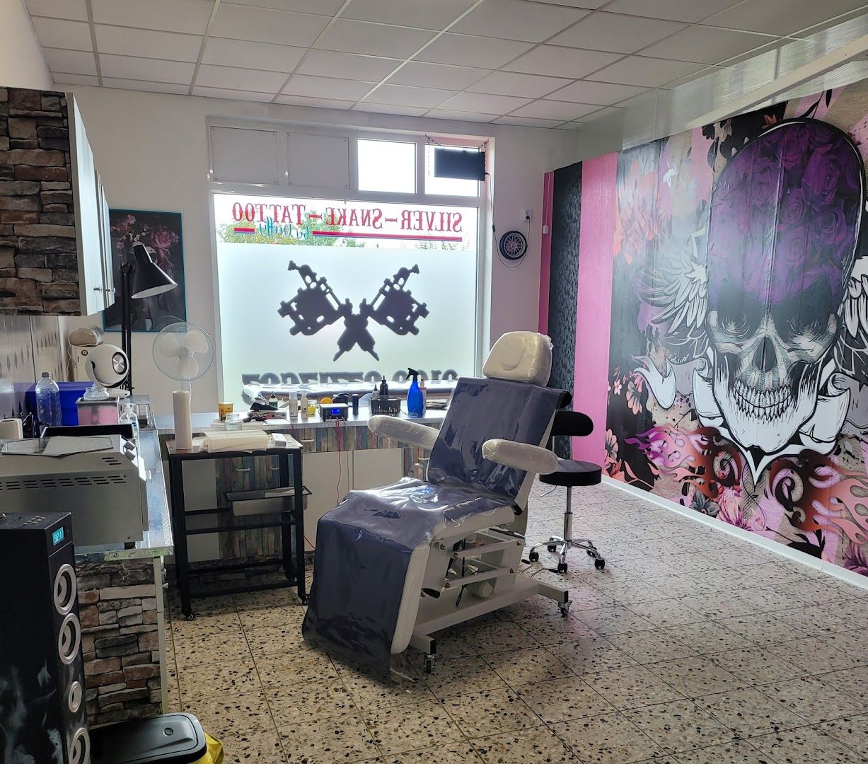 a room with a chair and a wall mural