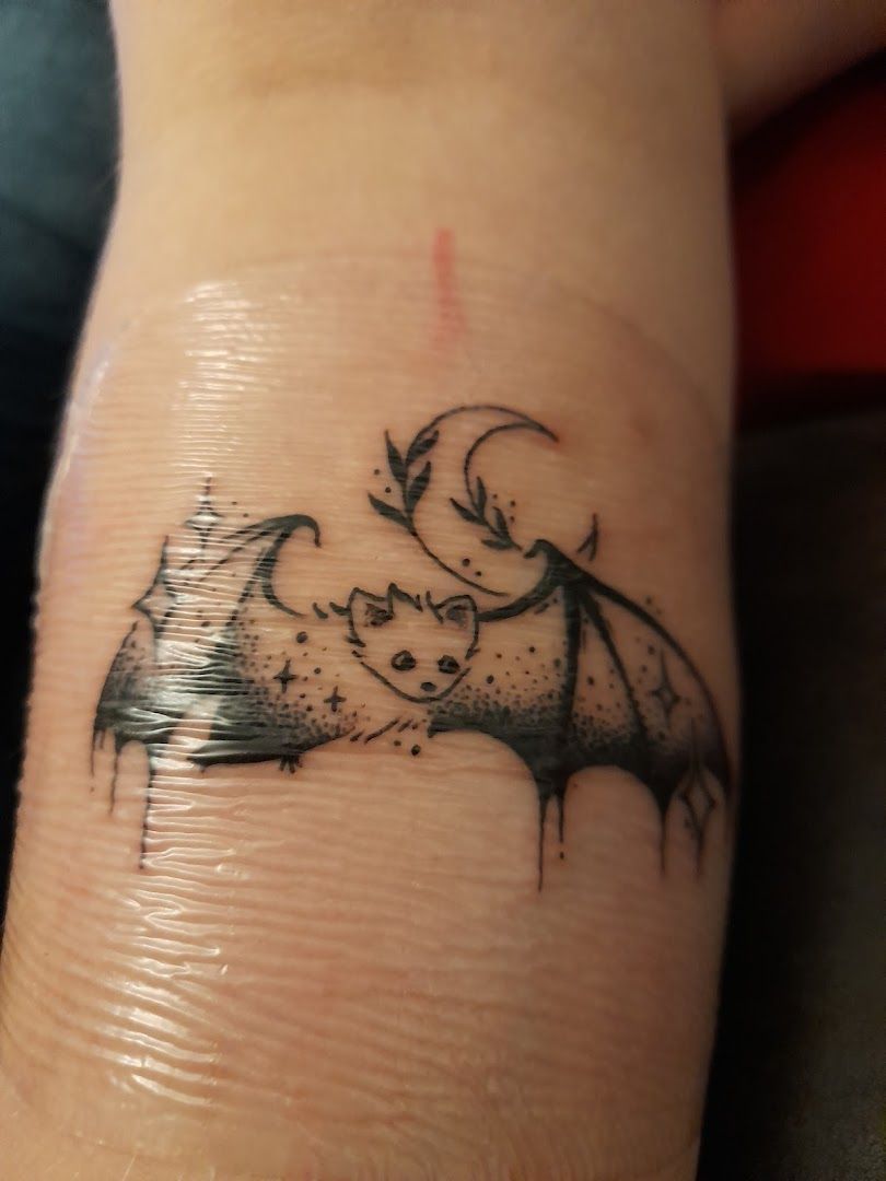 a cover-up tattoo of a bat on the wrist, bochum, germany