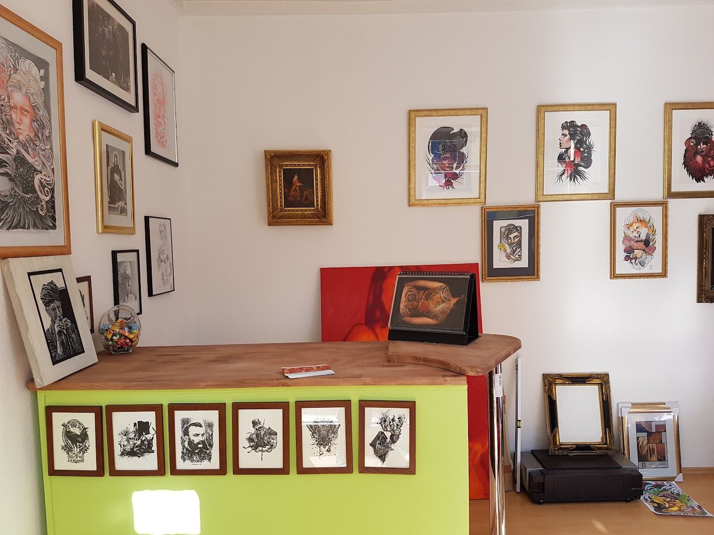a room with a desk and pictures on the wall