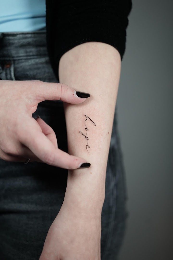 a woman's hand holding a small cover-up tattoo, bodenseekreis, germany