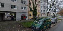 a street with cars parked in front of a building