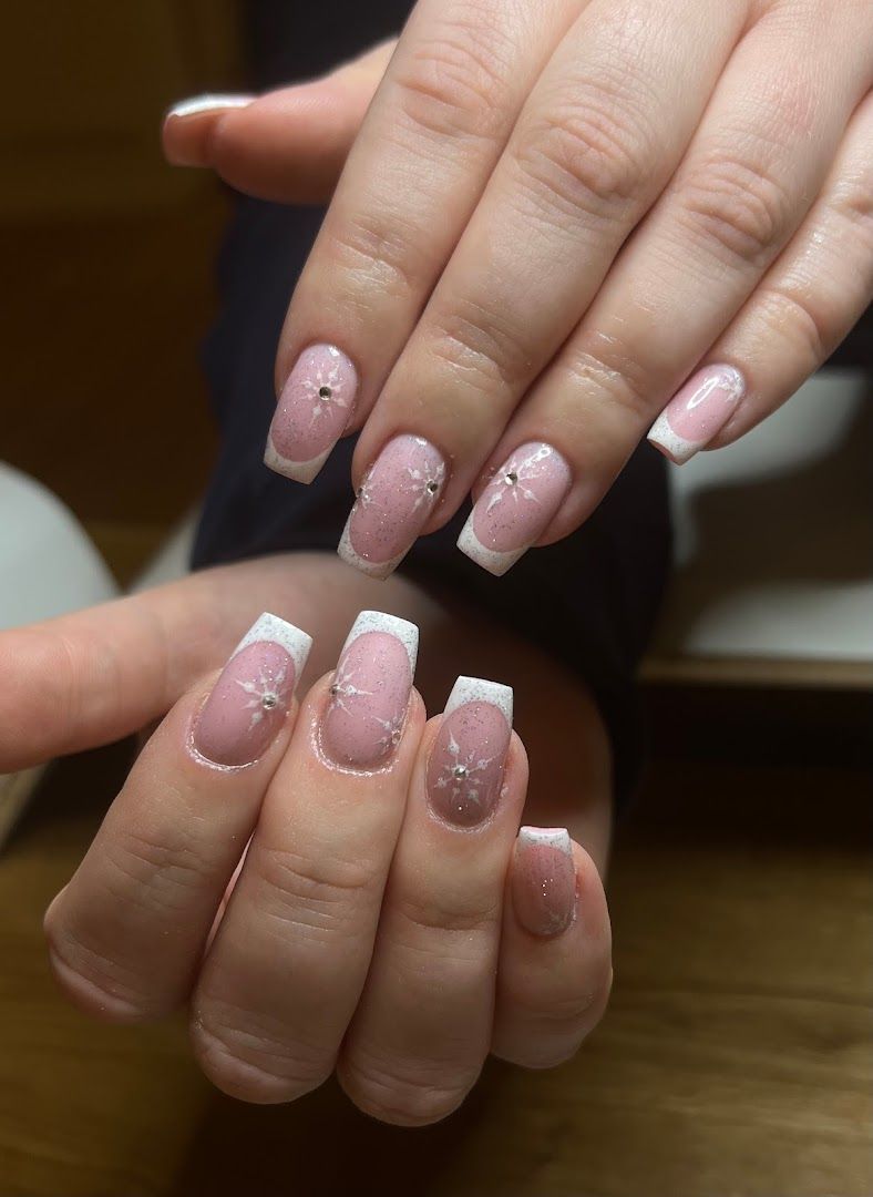 a woman's hands with pink and white french manies