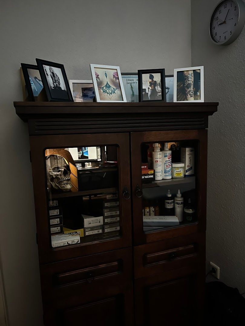 a cabinet with a clock and pictures on it