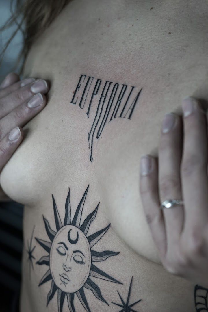 a woman with a sun cover-up tattoo on her chest, hamburg, germany