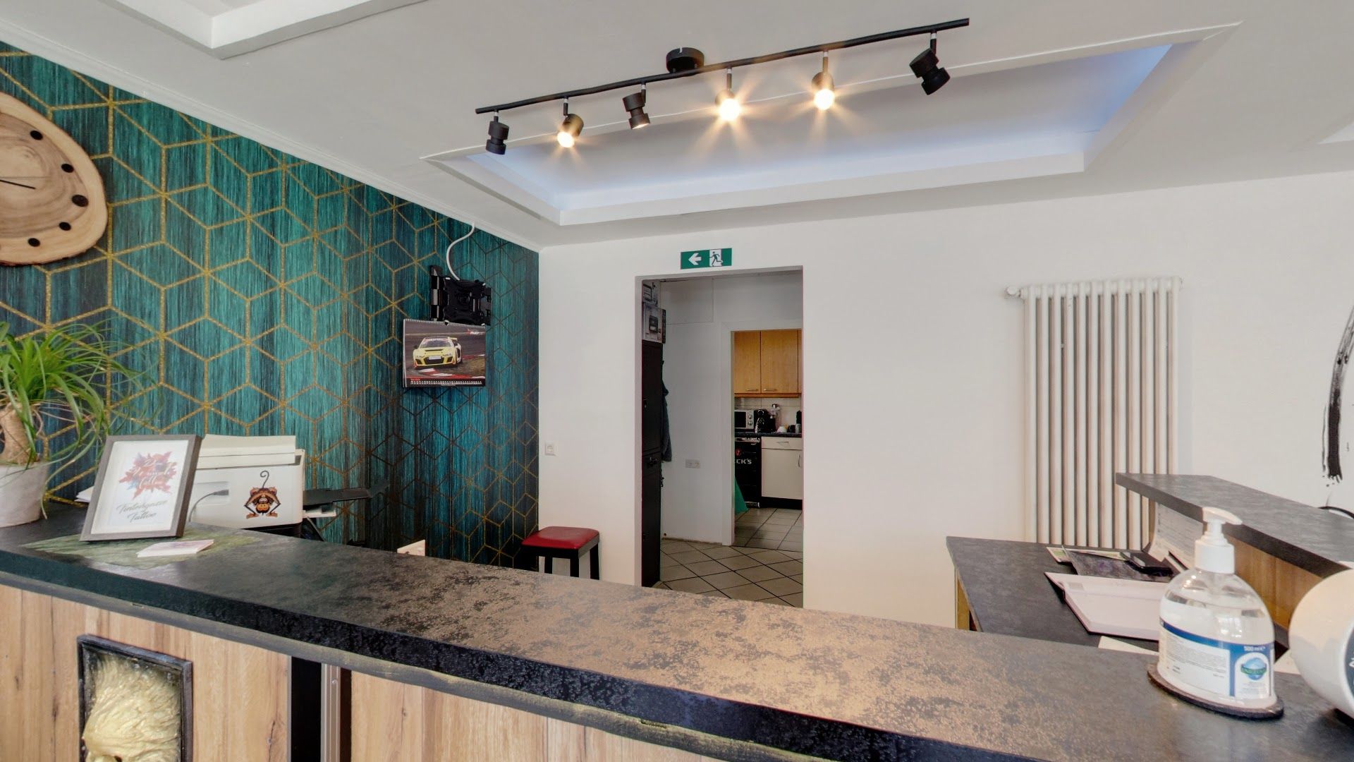 a kitchen with a counter and a wallpapered wall