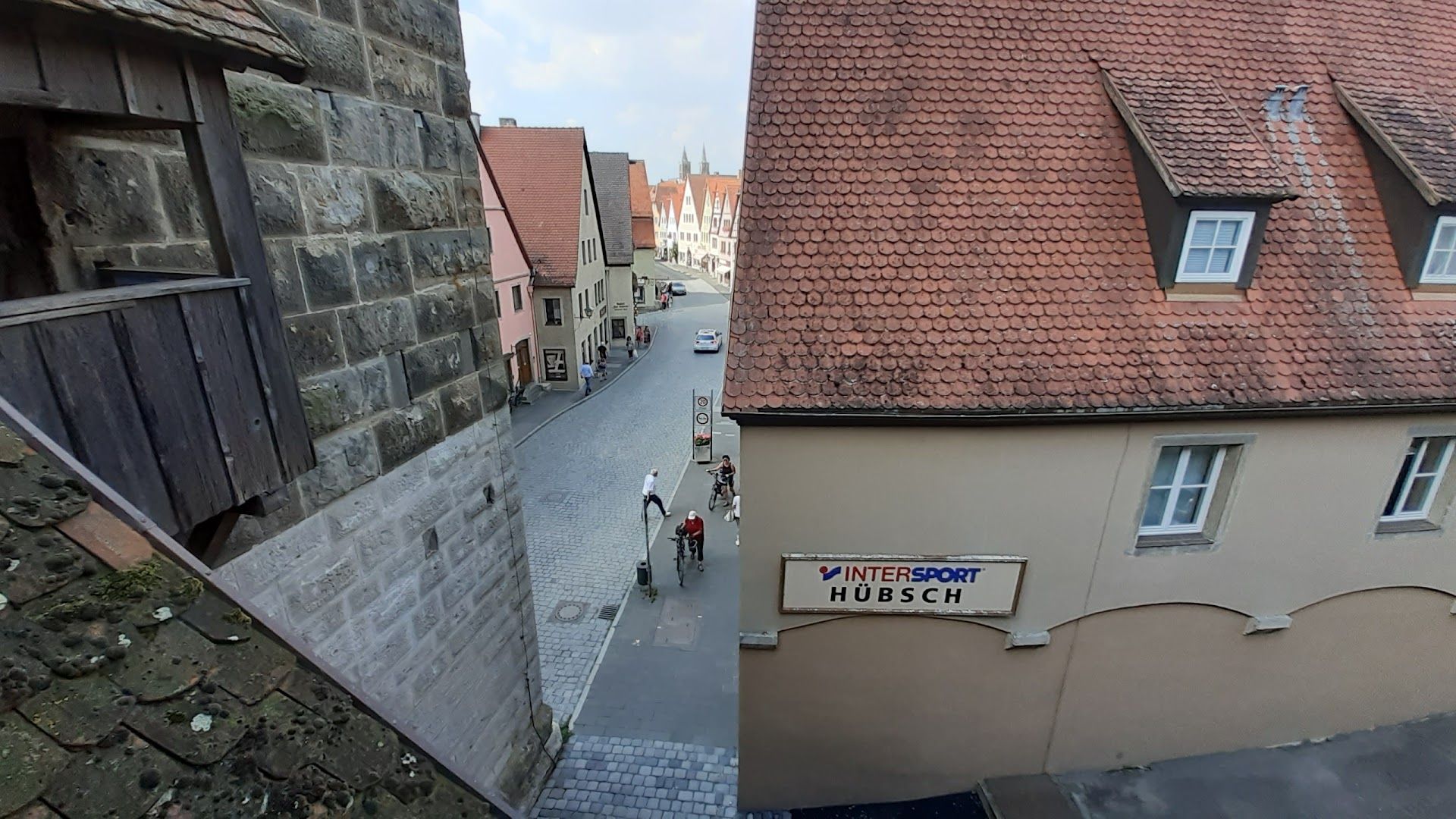 a view of a street with a building and a sign