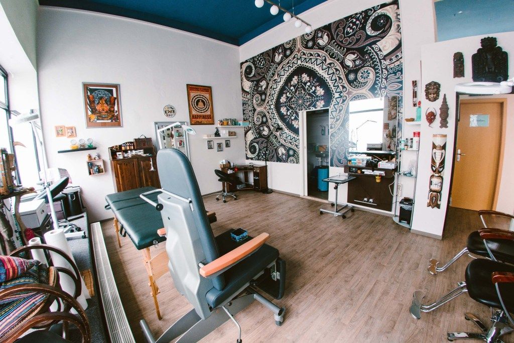 a room with a chair, desk and a wall mural