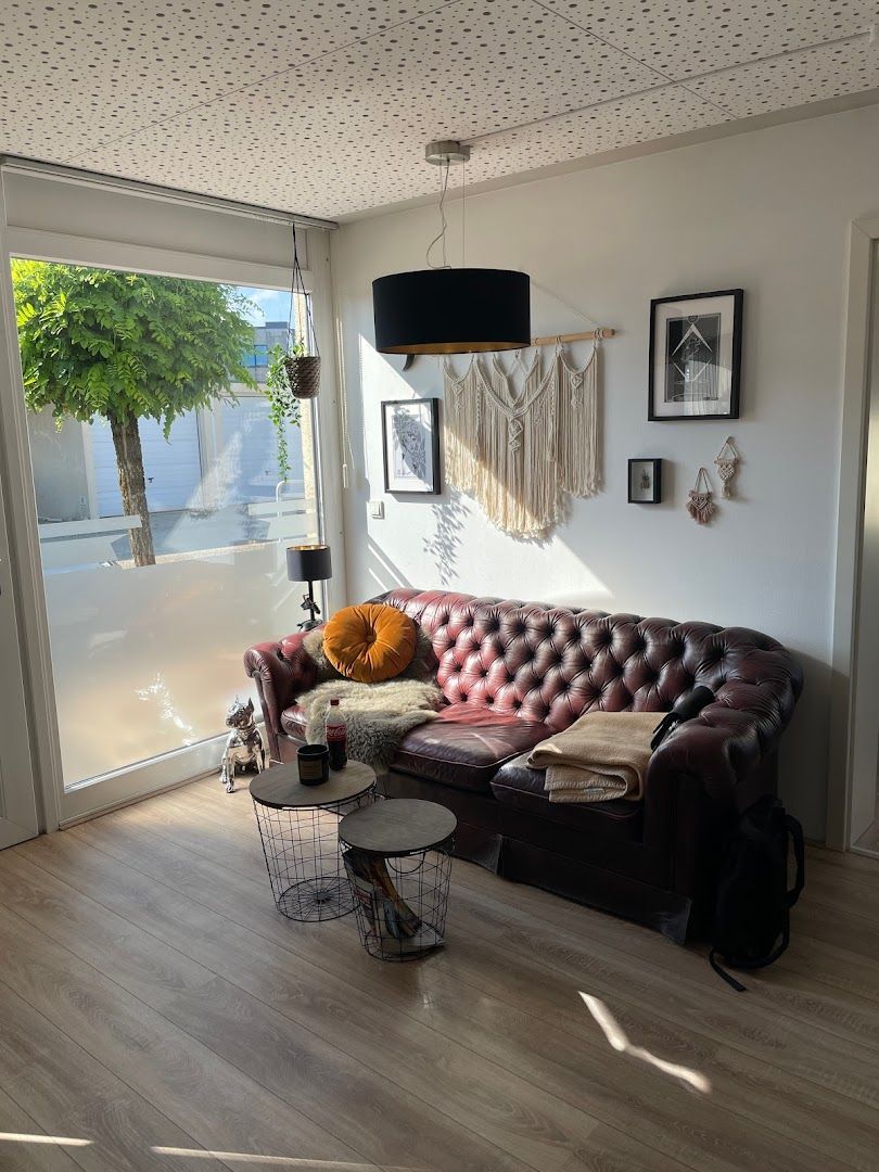 a living room with a couch and a lamp