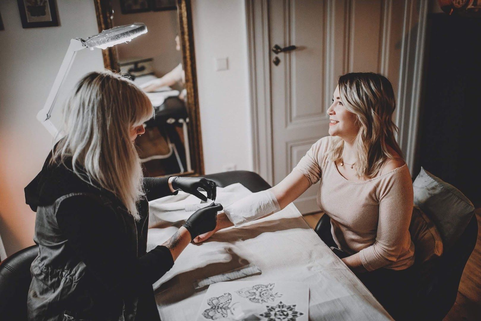 a woman getting her hair done by a hairdre