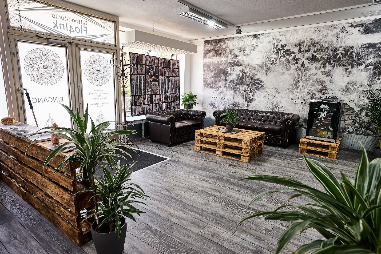 a room with a couch, a table and a plant