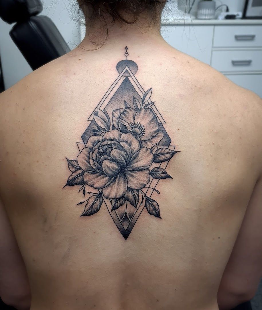 a woman with a cover-up tattoo on her back, mettmann, germany