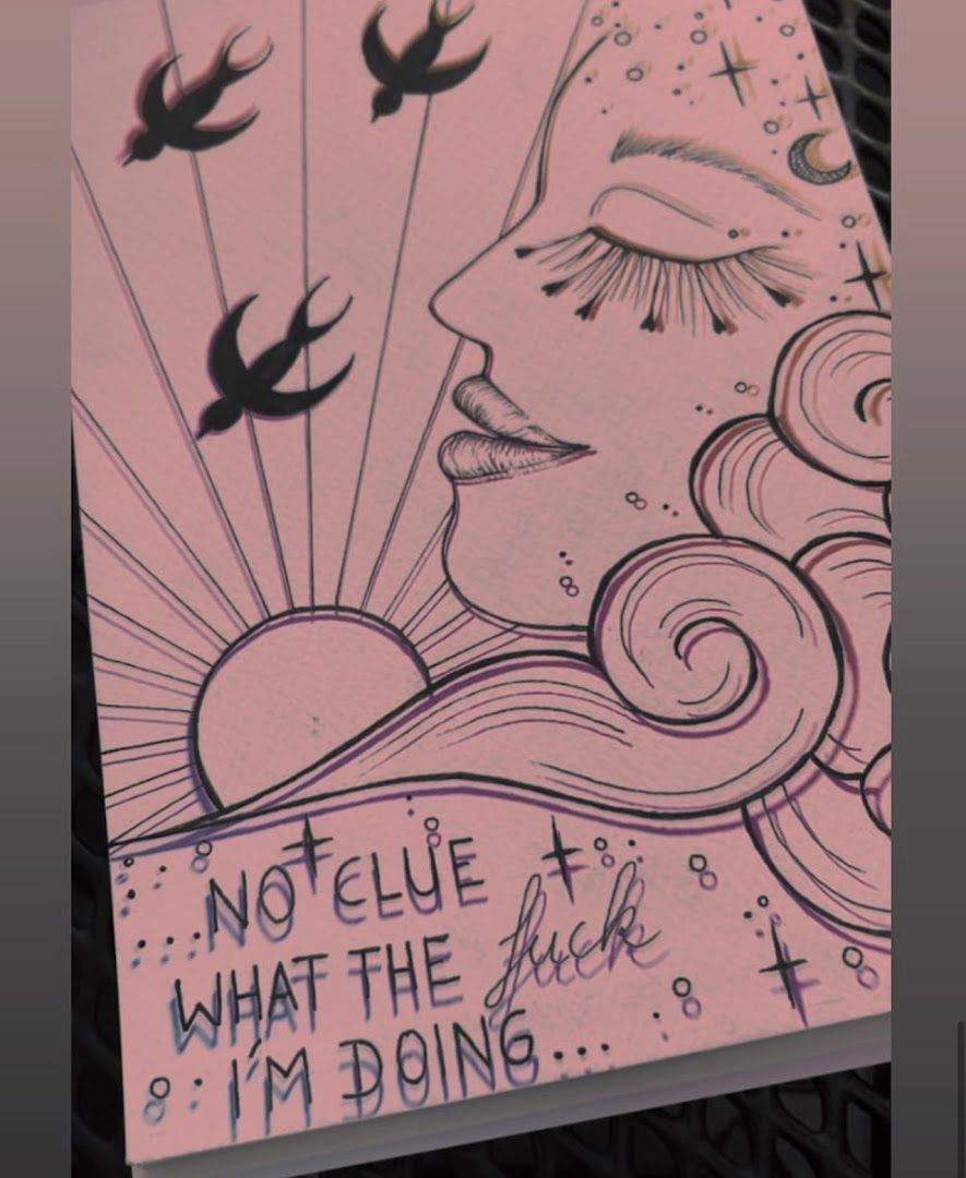 a pink poster with a drawing of a woman's face and birds flying around her