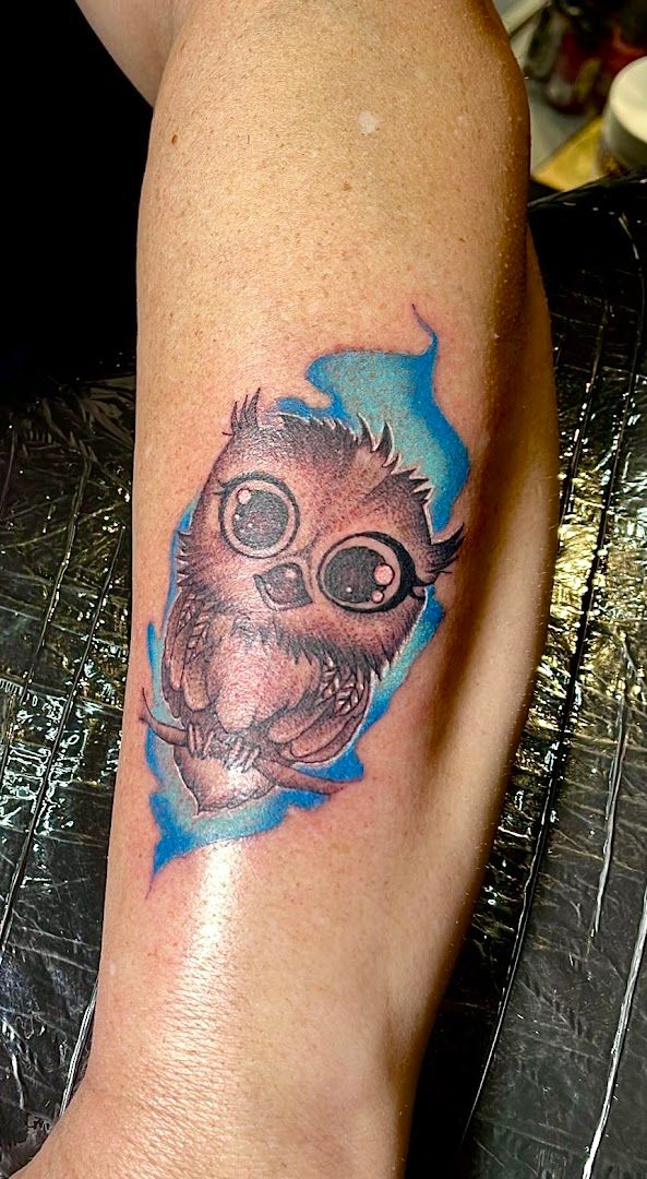 a cover-up tattoo of an owl on the arm, schmalkalden-meiningen, germany