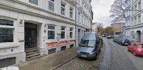 a street with cars parked in front of a building