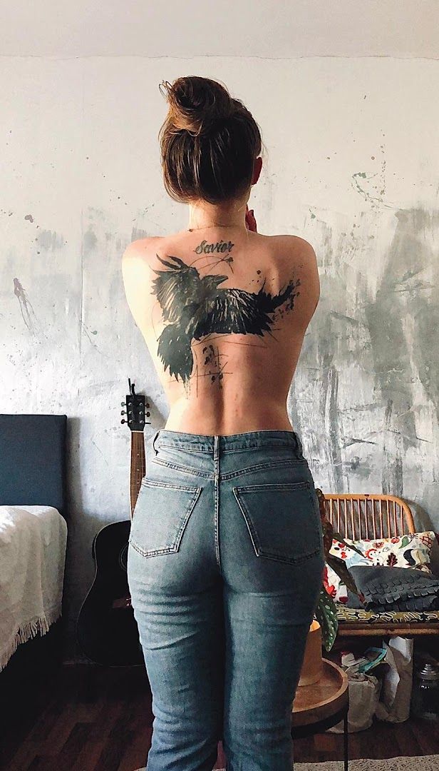 a woman with a cover-up tattoo on her back, bonn, germany