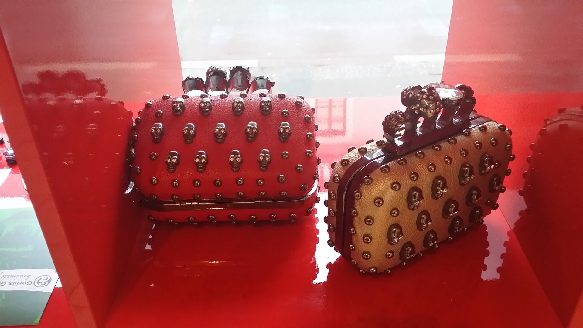 two red and gold purses on display