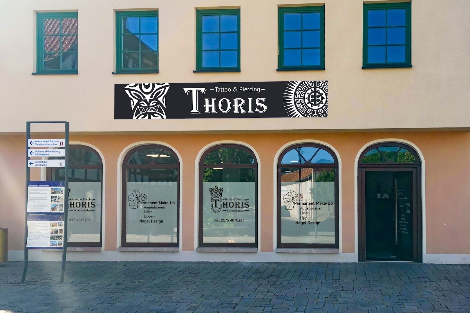 the entrance to the building with the sign for thors