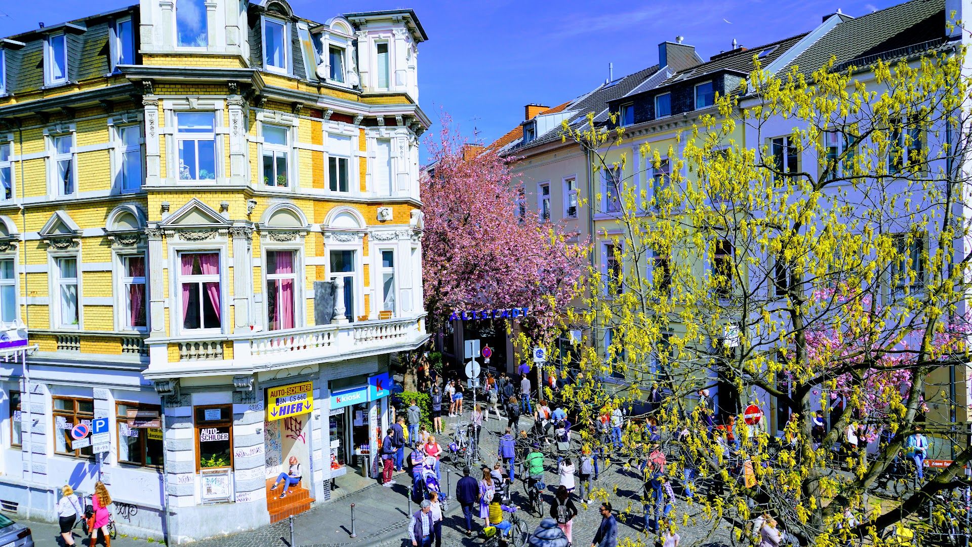 a street with many people walking around it