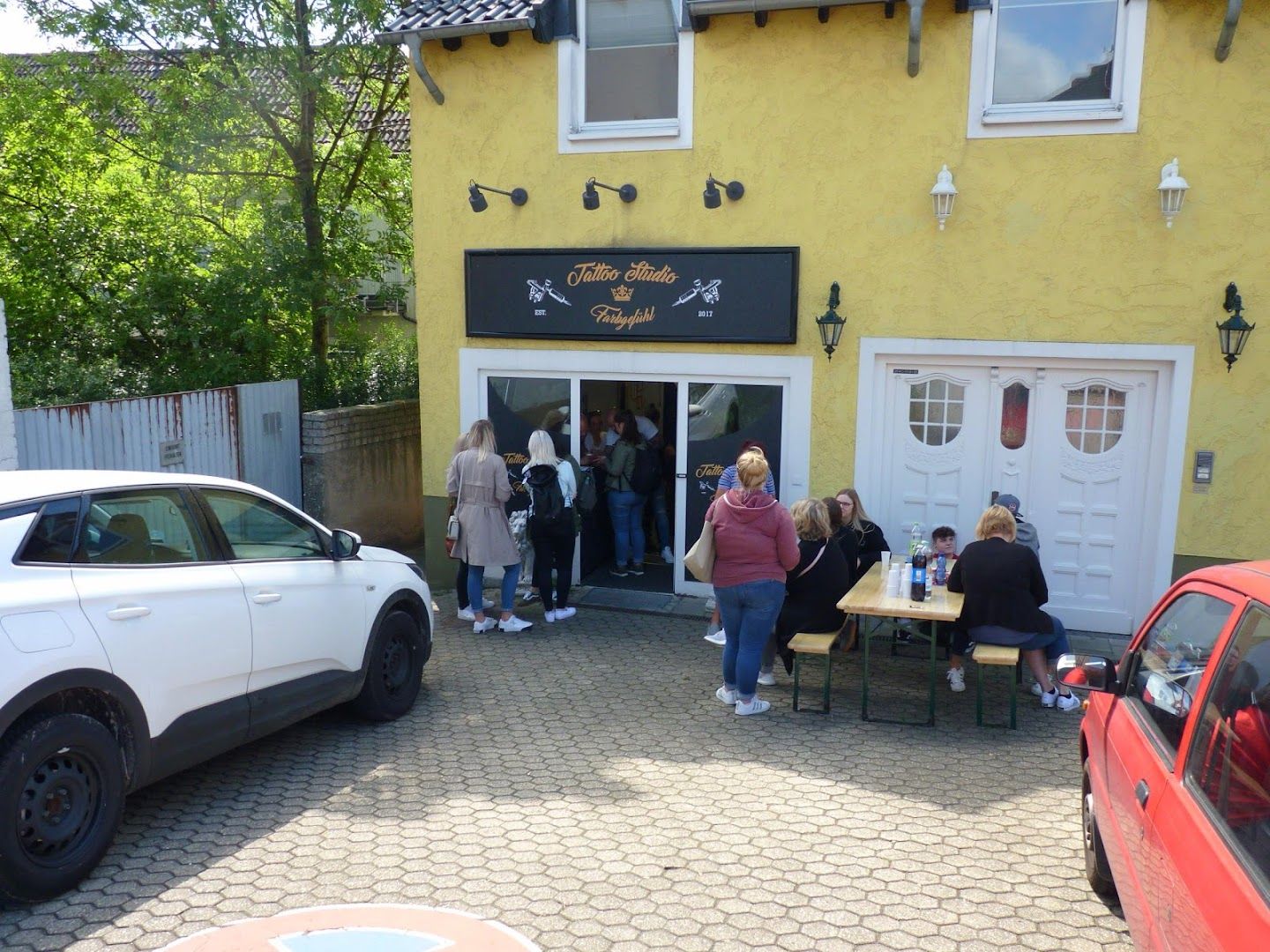 the outside of the restaurant with people outside