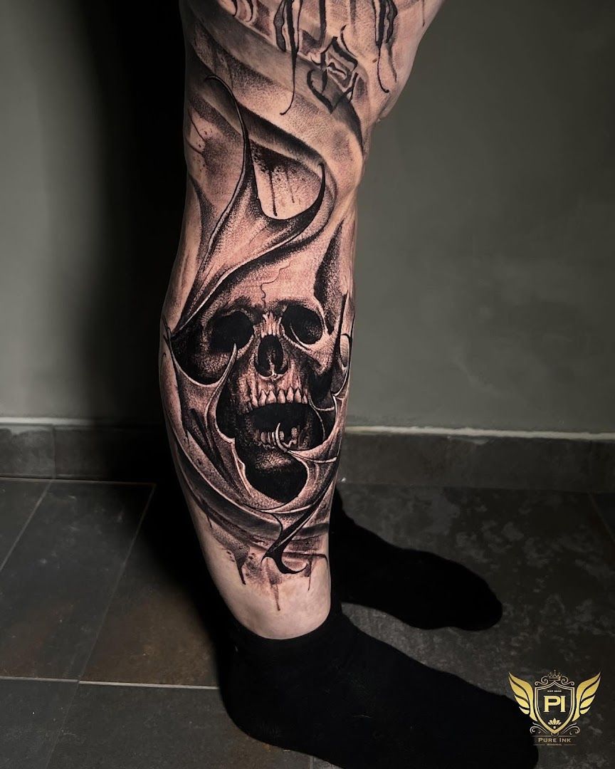 a man's leg with a skull and a skull on it