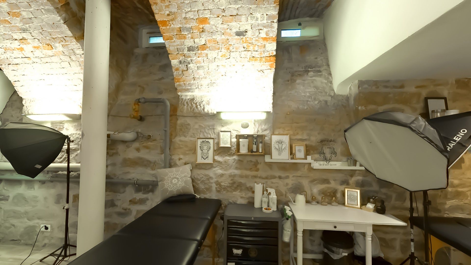 a room with a brick wall and a desk