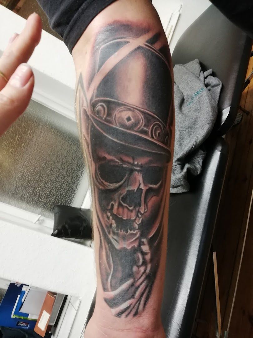 a man with a skull cover-up tattoo on his arm, berlin, germany