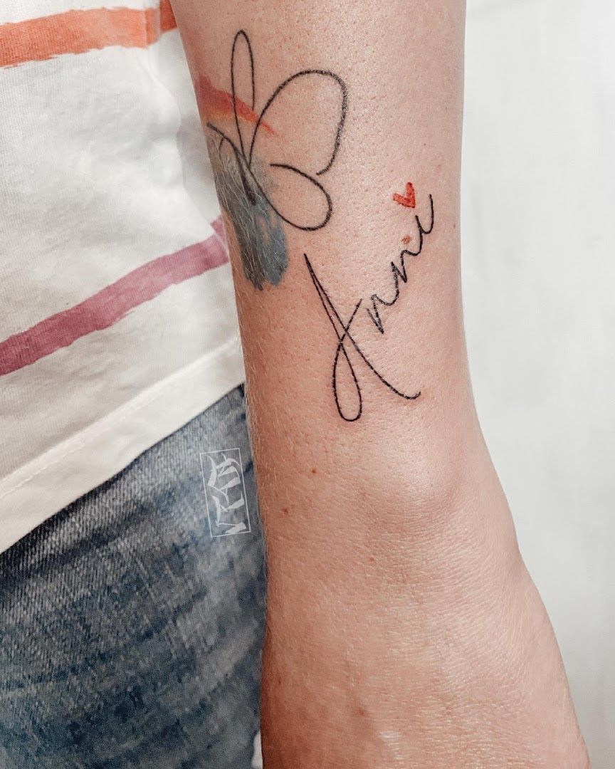 a woman's wrist cover-up tattoo with a heart and a name, olpe, germany