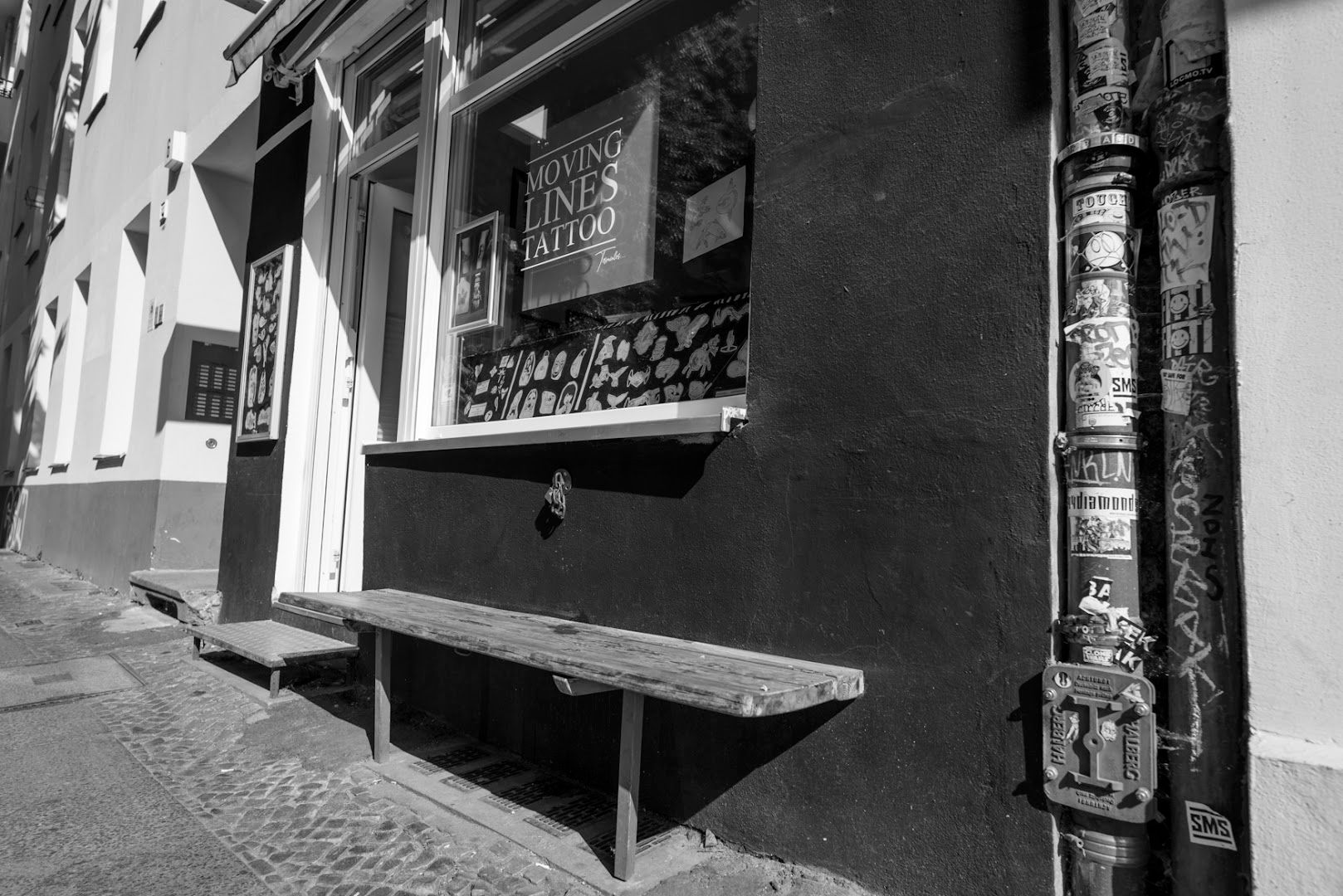 a bench in front of a building with a sign on it