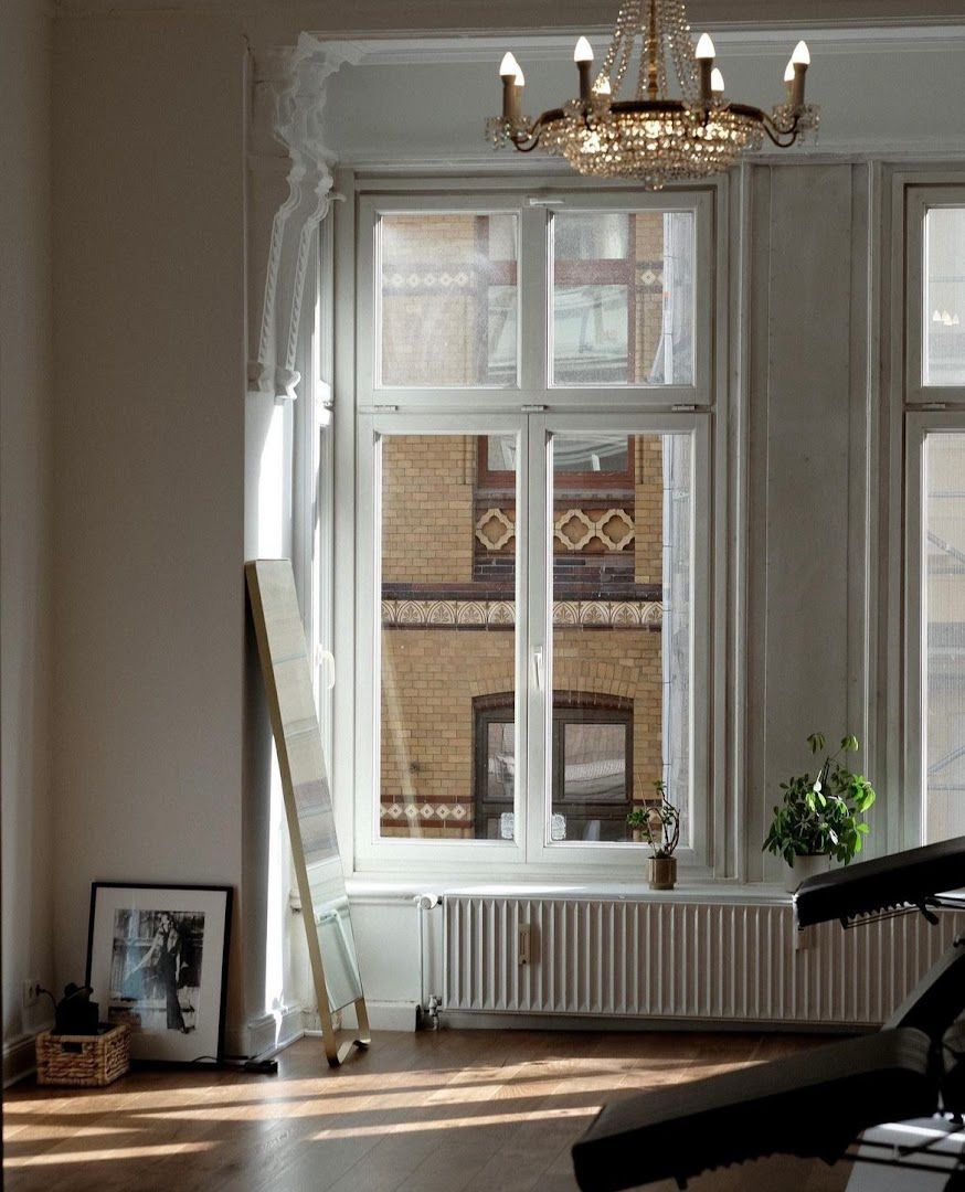 a room with a piano and a window