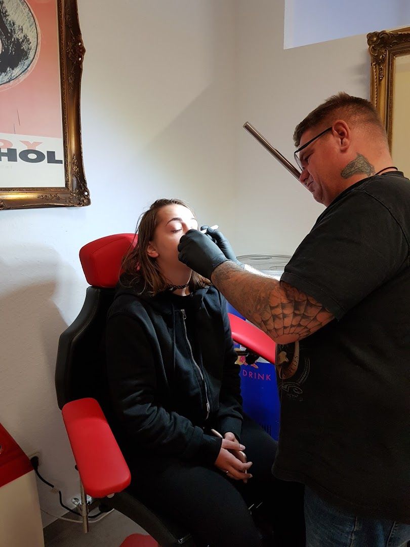 a man getting his hair cut by a woman