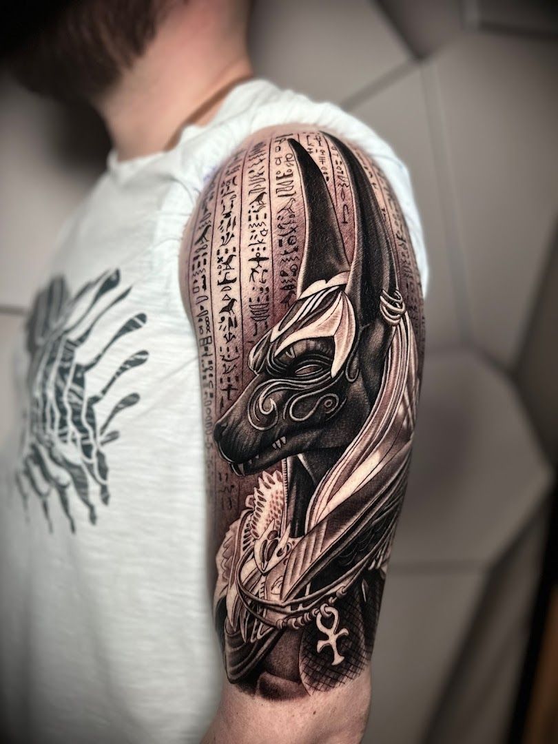 a man's arm with a cover-up tattoo of a bird and a book, herford, germany