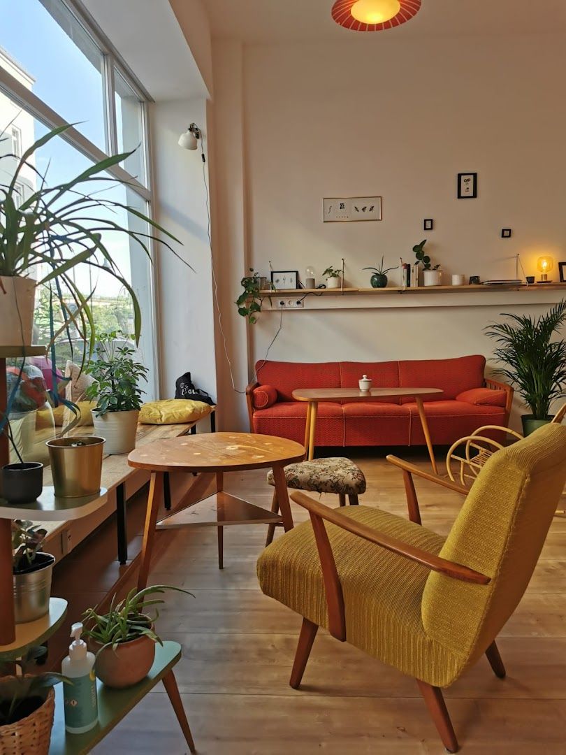 a living room with a couch, chairs and a table