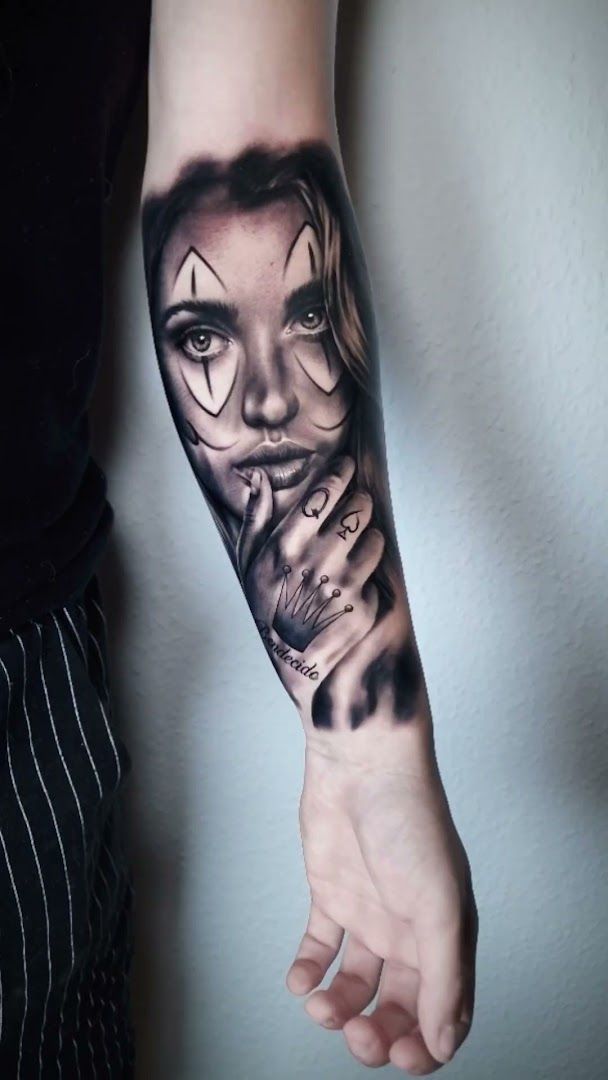 a woman's face with a skull on her arm