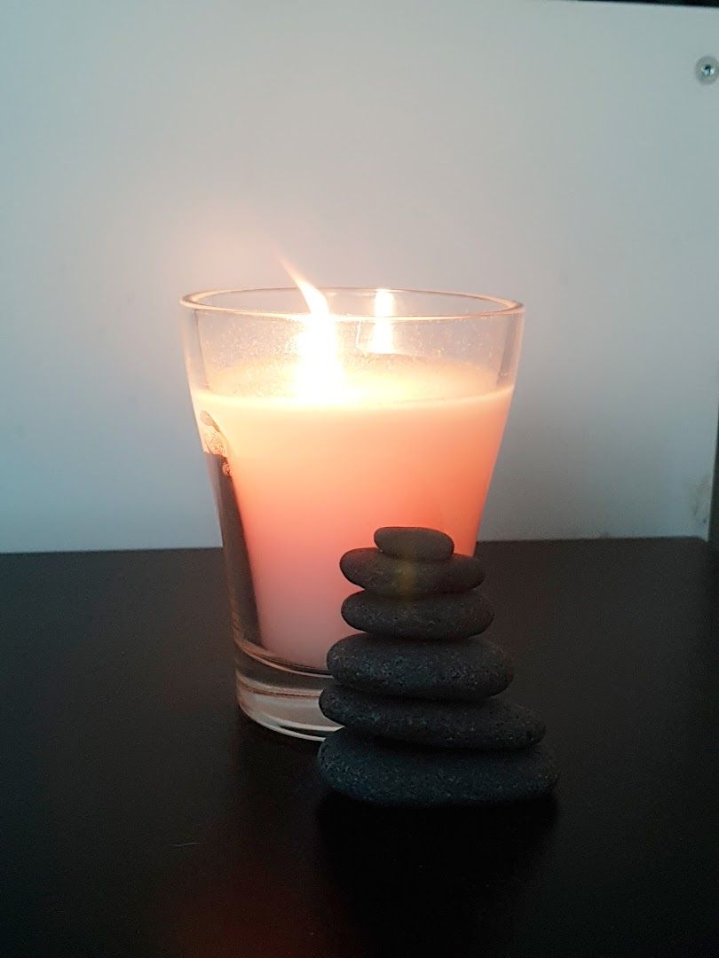 a candle and some rocks on a table