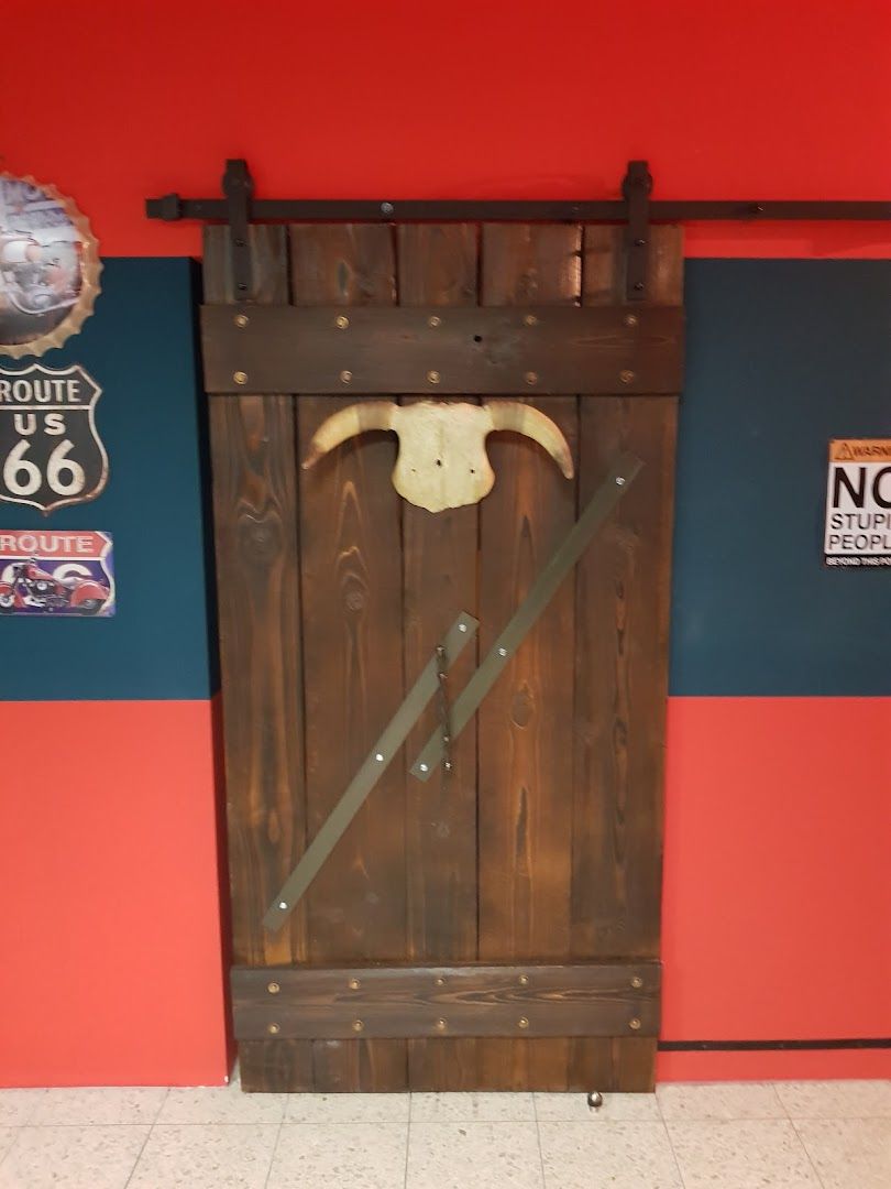 a wooden door with a cow skull on it