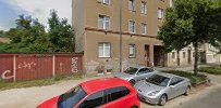 a red car parked in front of a building