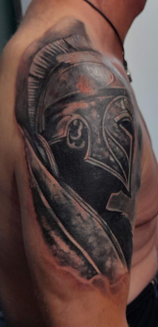 a man with a black and grey narben tattoo on his shoulder, dortmund, germany