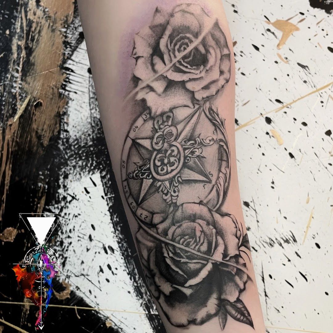 a black and white cover-up tattoo with roses and a compass, berlin, germany