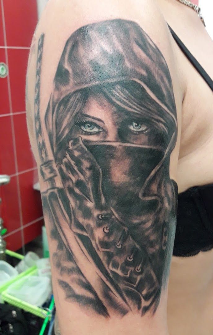 a woman with a black and grey cover-up tattoo on her shoulder, berlin, germany