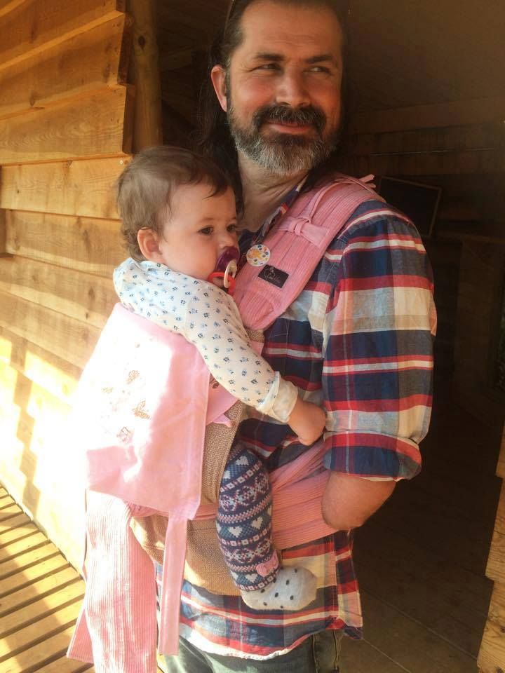 a man holding a baby in his arms