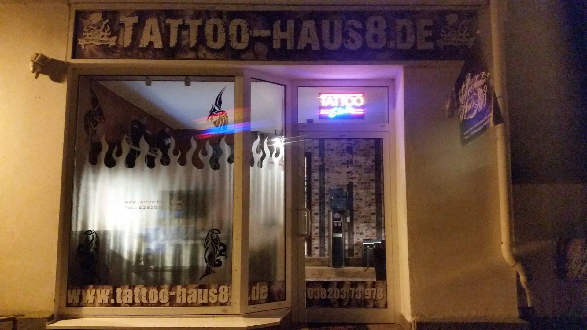 a store front with a sign that says japanische tattoos in leipzig house, rostock, germany