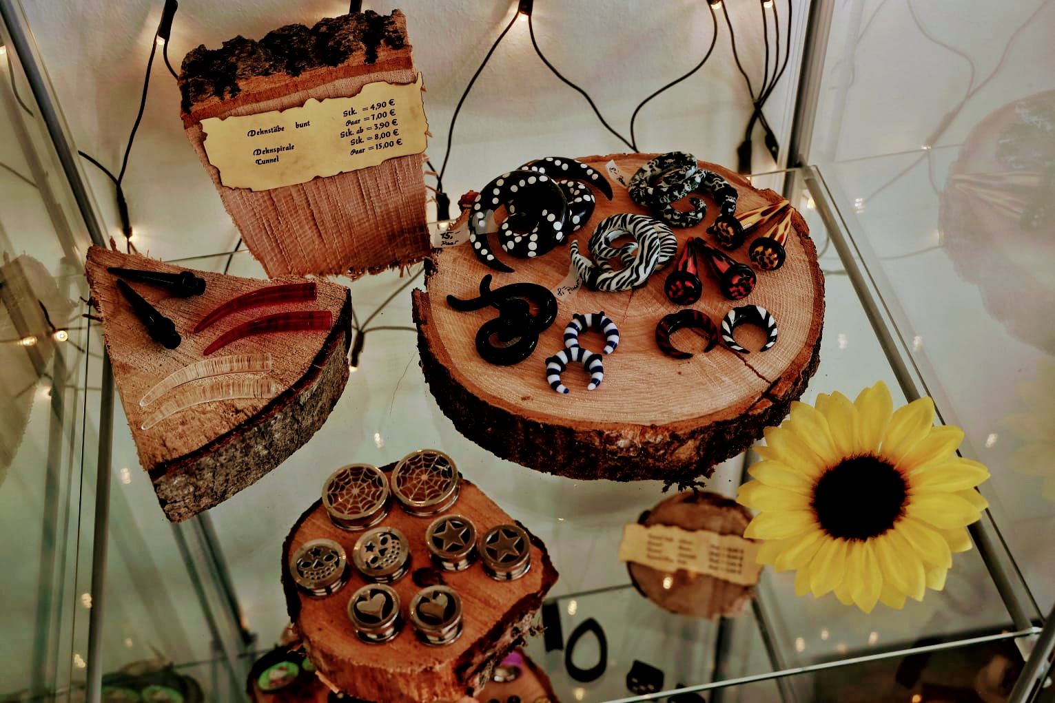 a display of jewelry and flowers in a glass case