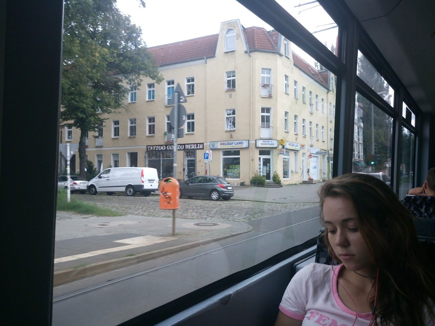 a girl sitting in a bus looking out the window