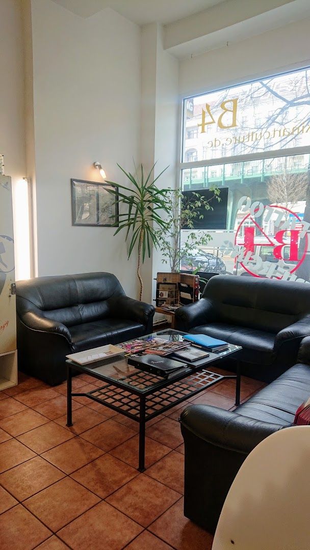 a living room with black leather couches and a coffee table