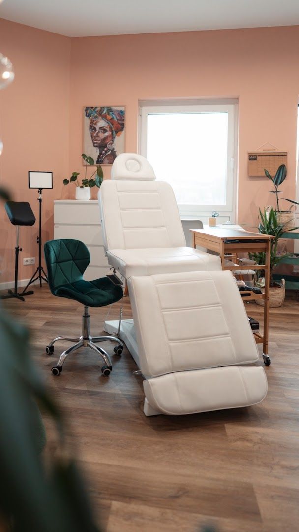 a white rec chair in a room with a plant