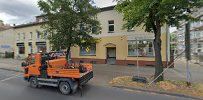 a street with a tractor and a building