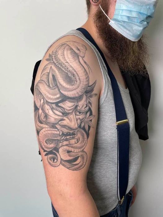 a man with a mask and a snake narben tattoo on his arm, kreisfreie stadt passau, germany